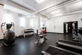 Des Moines apartment for rent - A gym with a treadmill, weights, and exercise equipment.