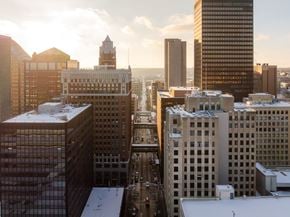 Des Moines apartment for rent - A cityscape with buildings and a clock tower.