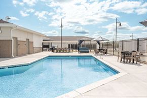 La Vista apartment for rent - A large swimming pool with a white fence surrounding it.