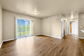 Des Moines apartment for rent - A room with wooden flooring and sliding glass doors at Melbourne Apartments in Des Moines, Iowa 50320.
