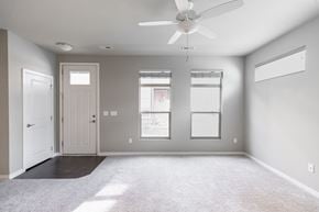 Des Moines apartment for rent - A room with a ceiling fan and a window.