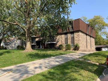 Newton apartment for rent - A house with a tree in front of it.
