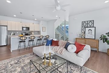 West Des Moines townhouse for rent - A modern living room with a white couch and a glass coffee table.
