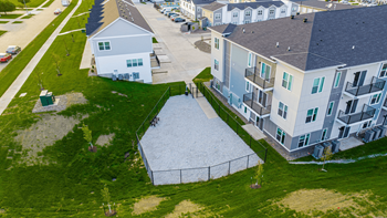 An aerial view of a row of houses with a sidewalk