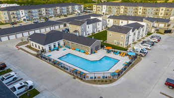 An aerial view of an apartment complex with a swimming pool