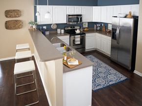 Waukee apartment for rent - a kitchen with stainless steel appliances and a long counter top at The Winhall of Williams Pointe Apartments, Waukee