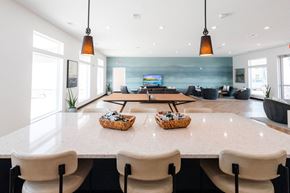 Waukee apartment for rent - a large dining room with tables and chairs and a television in the background at Converge NW, Waukee, 50263  