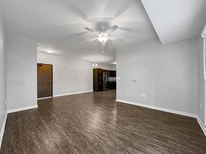 Clive apartment for rent - A spacious room with wood flooring and a ceiling fan. at Stonegate Crossing Apartments, Clive, 50325