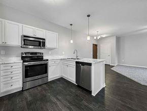 Clive apartment for rent - an empty kitchen with white cabinets and stainless steel appliances at Stonegate Crossing Apartments, IOWA, 50325