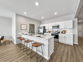 Waukee apartment for rent - a large typographic wall in a room with bar stools at Rialto Townhomes Apartments, Iowa, 50263