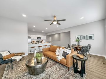 Waukee apartment for rent - A living room with a brown couch and a coffee table.
