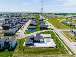 Waukee apartment for rent - an aerial view of a neighborhood of houses in a field at Rialto Townhomes Apartments, Waukee, IA, 50263