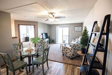 Sioux Falls apartment for rent - A living room with a glass table and chairs.