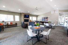 Des Moines apartment for rent - A conference room with a table, chairs, and a television on the wall.
