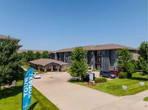 Des Moines apartment for rent - A banner that says "Tour Today" is in front of a building.