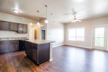 Des Moines apartment for rent - A kitchen with dark wood cabinets and a light colored floor.
