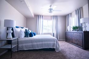 Des Moines apartment for rent - A bedroom with a bed, nightstand, and dresser.
