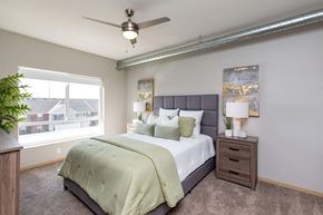 Ankeny apartment for rent - a bedroom with a large bed and a ceiling fan at Lake Shore Apartments, Iowa, 50021