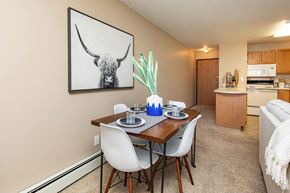 Ankeny apartment for rent - our apartments offer a dining room table with chairs and a view of the kitchen at Lake Shore Park, Iowa
