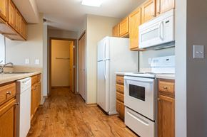 Waukee apartment for rent - a kitchen with wood flooring and white appliances at Sunrise Meadows, Waukee