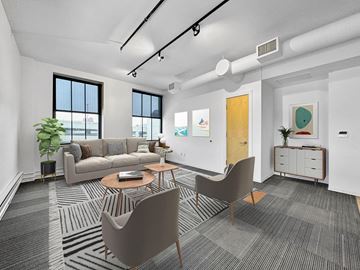 Des Moines apartment for rent - A modern living room with a grey carpet and a brown chair.