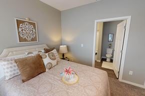 Altoona apartment for rent - A bedroom with a large bed and a painting on the wall. at The Barclay Apartments, Altoona