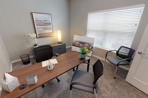 Altoona apartment for rent - A conference room with a long table, chairs, and a framed picture on the wall. at The Barclay Apartments, Altoona, IOWA