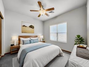 Johnston apartment for rent - A bedroom with a large bed and a ceiling fan.at Cornerstone Commons, Johnston  