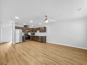 Bondurant apartment for rent - A kitchen with wooden floors and white walls.