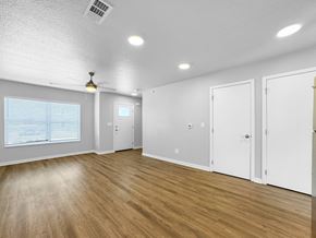 Bondurant apartment for rent - A room with wooden floors and white walls.at Hawthorne Pointe, Iowa, 50035
