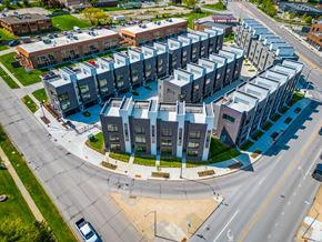Des Moines apartment for rent - an aerial view of an apartment building with cars driving around it at Matilda 235 Townhomes, Des Moines, IA