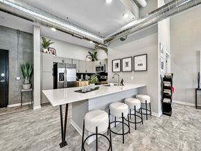 Des Moines apartment for rent - A kitchen with a white counter and bar stools.at Level, Des Moines Iowa   