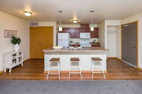 Des Moines apartment for rent - a kitchen with a large island with three bar stools at Melbourne Apartments, Iowa, 50320