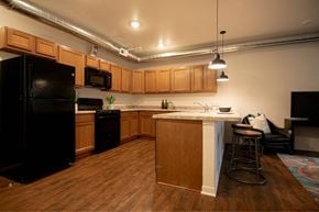 Des Moines apartment for rent - a kitchen with an island and a black refrigerator at Melbourne Apartments, Des Moines, IA,  50320
