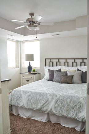 Grimes apartment for rent - A bedroom with a bed, dresser, and ceiling fan at Meadowlark Place Apartments, IA, 50111