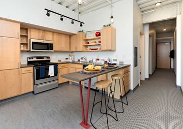 Des Moines apartment for rent - A kitchen with a table and chairs in the middle of the room.
