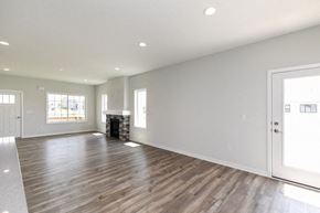 West Des Moines apartment for rent - A large empty room with wooden floors and white walls. at Two Rivers Home Rentals, West Des Moines, IA 50266