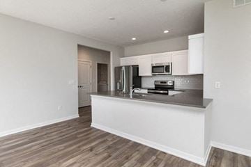 West Des Moines apartment for rent - A kitchen with white cabinets and a wooden floor.