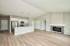 West Des Moines apartment for rent - an empty living room with a kitchen and a fireplace at Two Rivers Home Rentals, Iowa