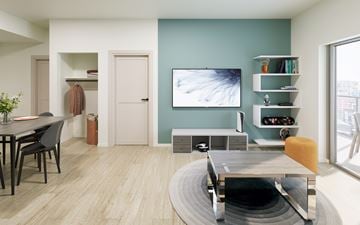 Waterloo apartment for rent - A modern living room with a grey table and a television on the wall.