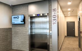 Waterloo apartment for rent - A modern elevator with a digital display and a glass door.