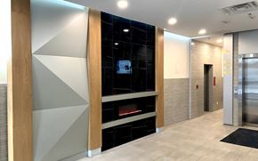 Waterloo apartment for rent - A modern hallway with a fireplace and a TV mounted on the wall.