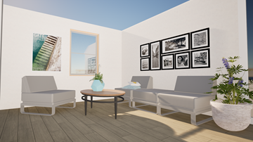 St. Agatha apartment for rent - A living room with a grey sofa, a white chair, a round table with a blue vase on it, and a wall with framed pictures.