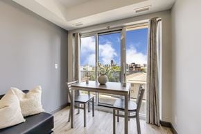 Waterloo apartment for rent - A dining room with a table and chairs and a view of the city.