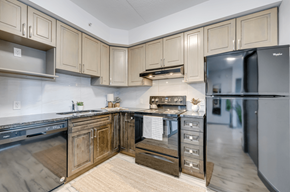 Waterloo apartment for rent - A kitchen with wooden cabinets and a black fridge.