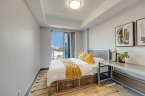 Waterloo apartment for rent - A bedroom with a bed, nightstand, and window.