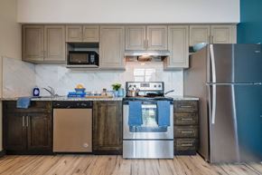 Waterloo apartment for rent - a kitchen with stainless steel appliances and wooden cabinets