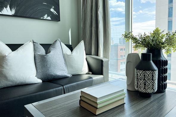 Waterloo apartment for rent - a living room with a couch and a table with books and a vase