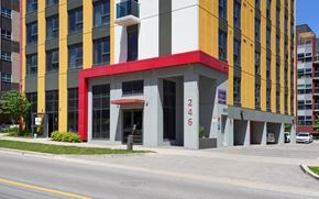 Waterloo apartment for rent - a building with a red and yellow facade on a city street