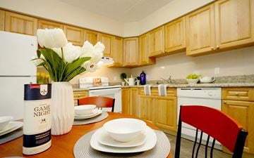 Waterloo apartment for rent - A kitchen with wooden cabinets and a table set for a meal.